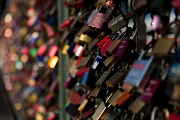 Love locks on a pedestrian and rail bridge in Köln crossing The River Rhine. 